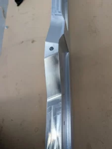 Aluminium part with precision milled contours