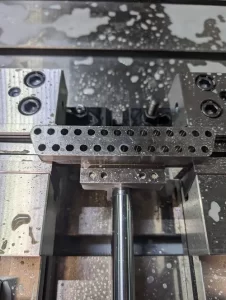 Assembled machined parts with rods and drilled plates