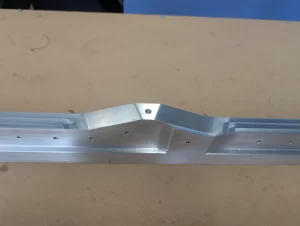Centre view of machined aluminium part with a sloped and angled surface