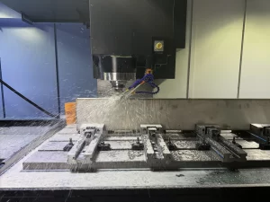 Close-up of CNC machine cutting with coolant spray
