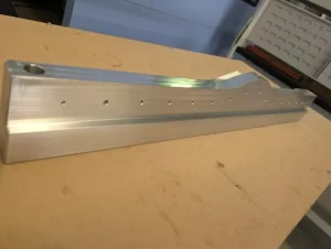 Close up of machined aluminium with drilled holes