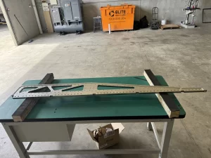 CNC-finished metal structure laid out for inspection