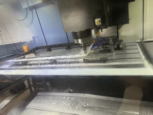 CNC machine cutting metal with coolant