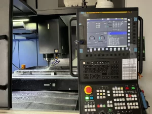 CNC machine operating with coolant spray and control panel view