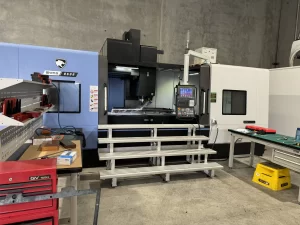 CNC machine performing precision milling on cylindrical aluminium part