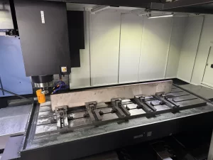 CNC machine with metal workpiece clamped for milling