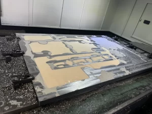 CNC milled plate with coolant spread and metal chips