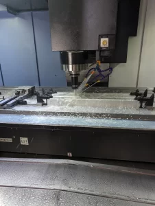 CNC milling machine in action on large aluminium block