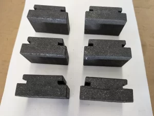 Compact view of six grooved blocks neatly aligned on paper