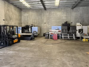 Forklift and CNC machining centre in a spacious industrial unit