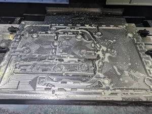 Freshly machined aluminium surface with curved milling patterns