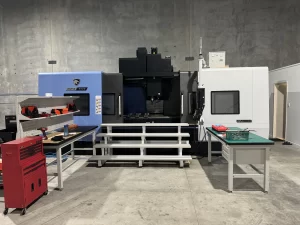 Fully installed CNC machine with workbenches and tools in place