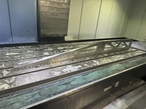 Machined aluminium component placed on CNC table