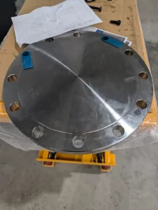 Machined circular metal flange with bolt holes