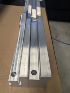 Machining setup showing aluminium part in CNC vice with coolant