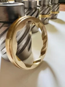 multiple machined threaded parts with fitted bronze rings