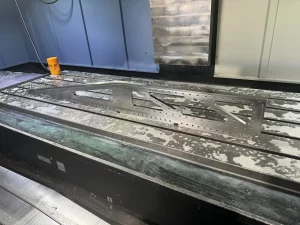 Precision-cut aerospace part on CNC bed
