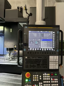 Side view of CNC controller and active machine head in operation