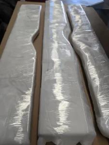 Side view of long aluminium component with stepped profile