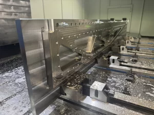 Side view of milled metal block with triangular cut-outs