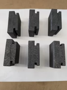 Six black rectangular blocks placed with groove side facing up