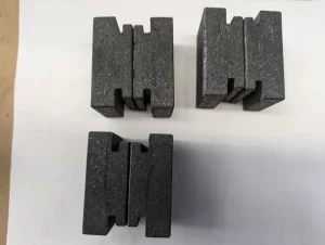 Three pairs of grooved black blocks arranged vertically