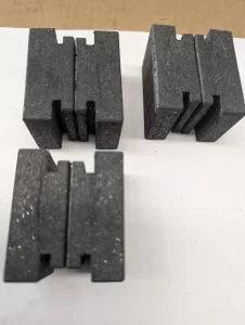 Top-down view of six black blocks grouped in threes
