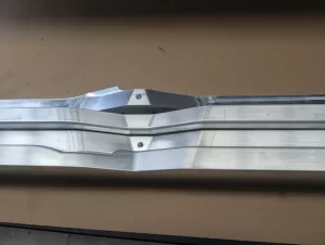 Top view of machined aluminium component with groove