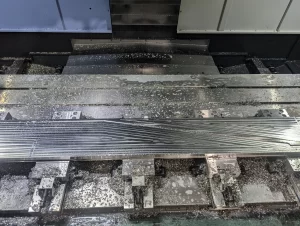 Top view of machined aluminium part with diagonal grooves