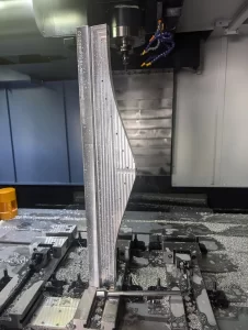 Vertical aluminium part clamped in CNC machine